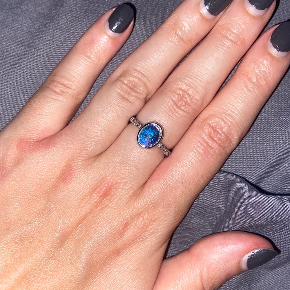 Silver ring with iridescent stone